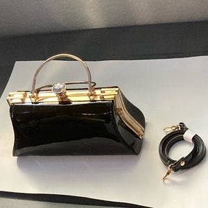 Black, gold accents, and large diamond medium size bag.